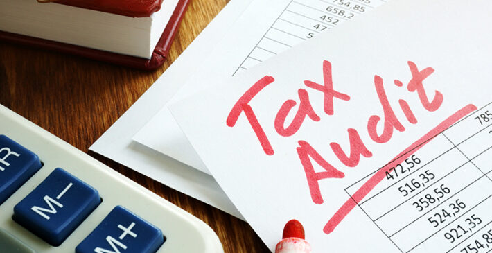 Tax audit handwriting on business accounting documents.